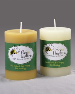 Two 3"x6" Twisted Octagonal Pillar - White beeswax candles with labels on them.