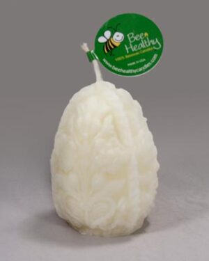 Ornate white beeswax candle with bee logo.