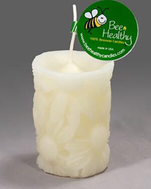 White beeswax candle with floral design.