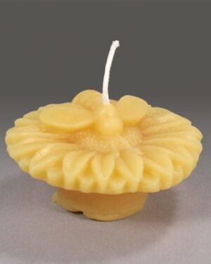 Yellow beeswax candle shaped like a flower.