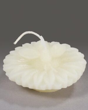 White flower shaped candle with wick.