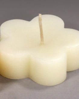 Three Floating Blossom - White beeswax candles on a gray background.