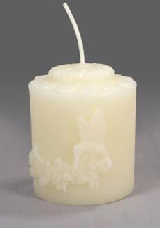 A Small Pine Cone - White beeswax candle with a butterfly on it.