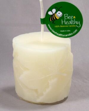 White beeswax candle with a bee logo.