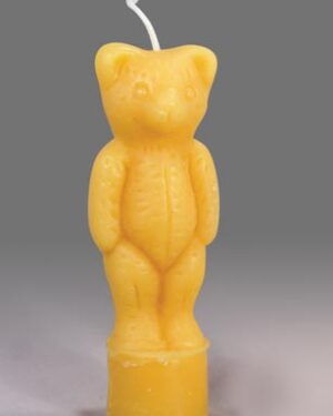 Yellow teddy bear shaped candle.