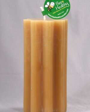 Honeycomb beeswax candle with bee label.