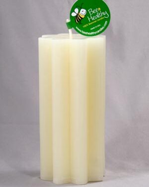 White pillar candle with bee logo.