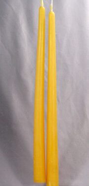 Two long yellow beeswax candles.