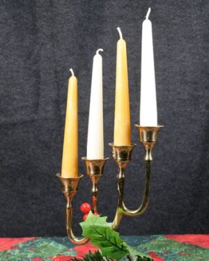 Gold candelabra with four lit candles.