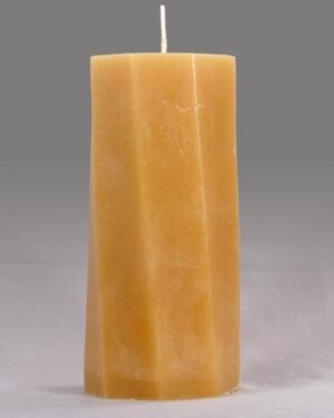 A tall, yellow, octagonal candle.