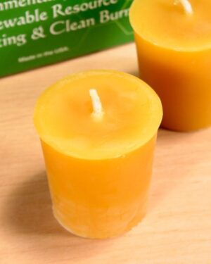 Two yellow beeswax votive candles.