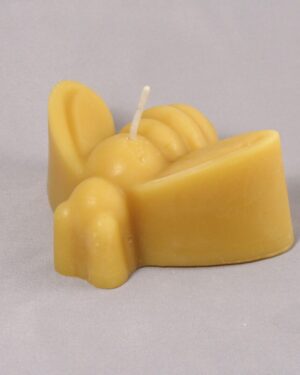 Yellow beeswax bee candle with wick.