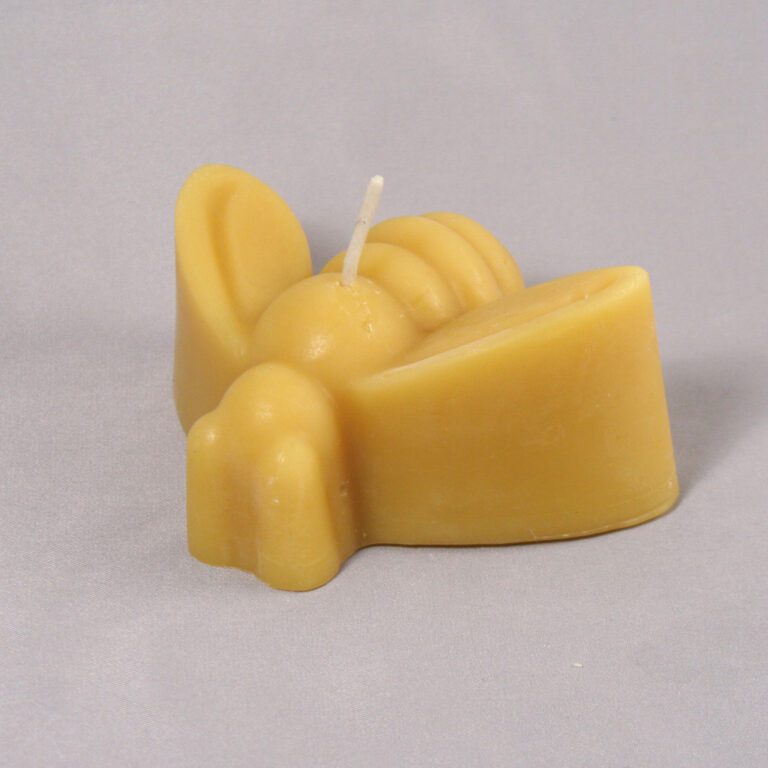 Yellow beeswax bee candle with wick.