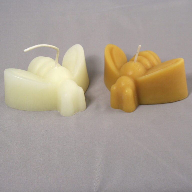 Two bee-shaped candles on a gray background.