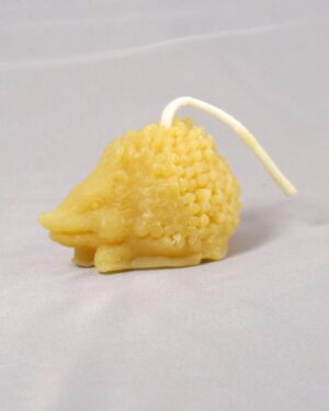 Yellow hedgehog shaped beeswax candle.