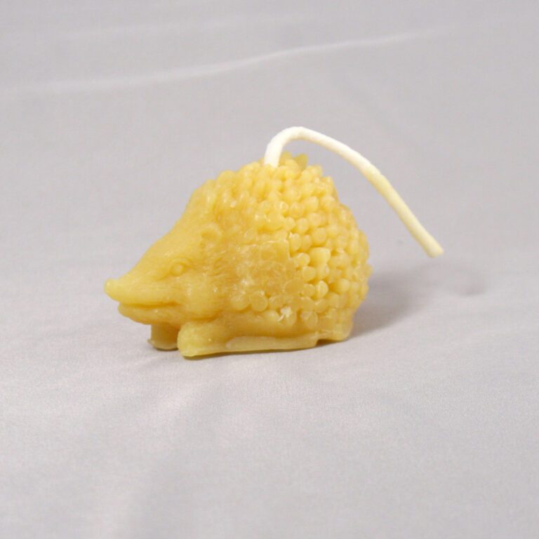 Yellow hedgehog shaped beeswax candle.