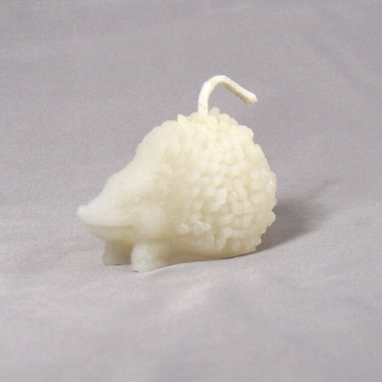 White hedgehog shaped candle with wick.