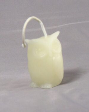 White owl shaped candle with a loop.