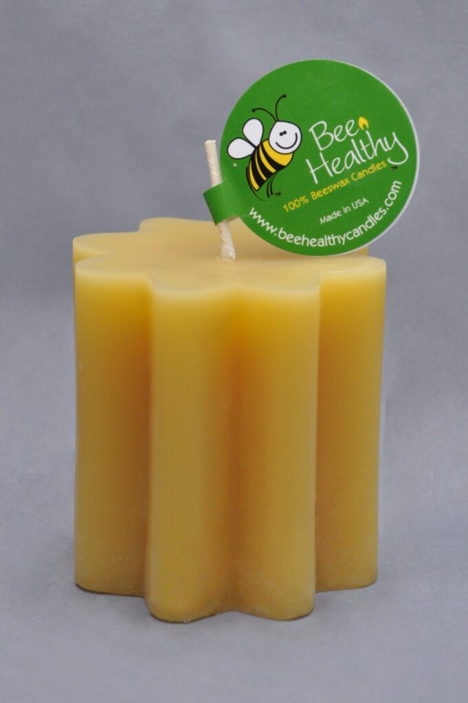 Yellow beeswax star shaped candle with wick.