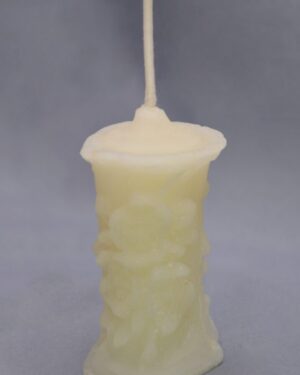 White pillar candle with a wick.