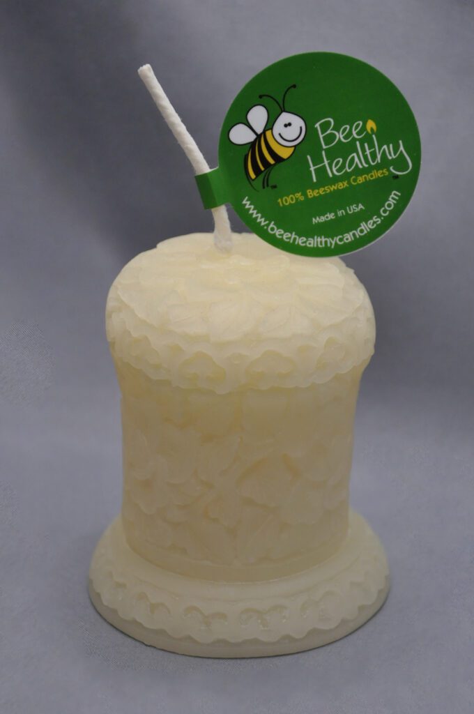 Beeswax candle with bee design.