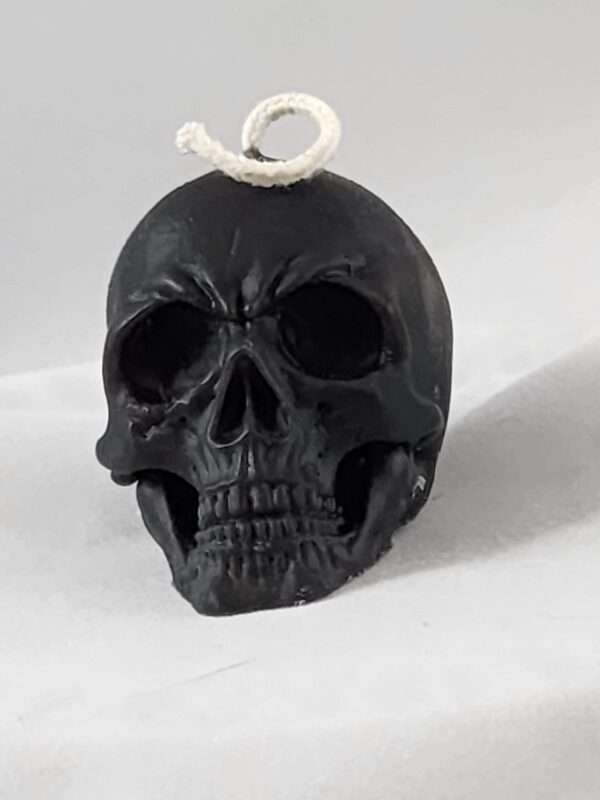 Black skull candle with white wick.